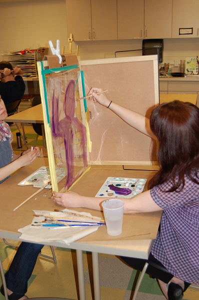 Art therapy student working on a painting